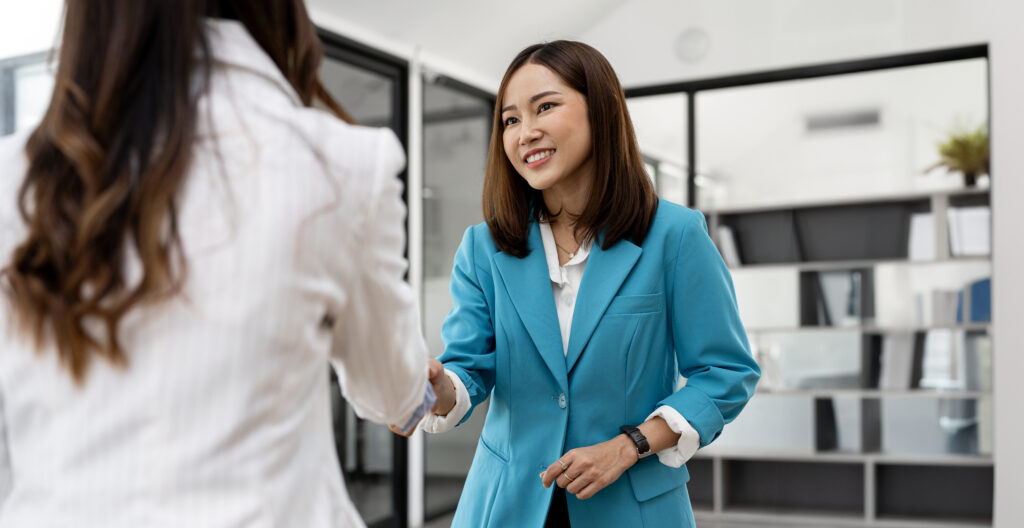 A medical device sales representative shaking hands with a doctor.