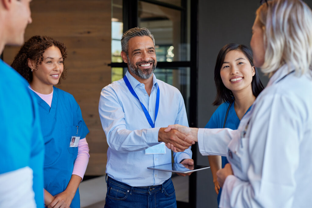 A medical device sales representative meets with medical team.